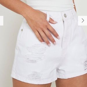 Never Worn white distressed denim shorts. Relax fit and high waisted.